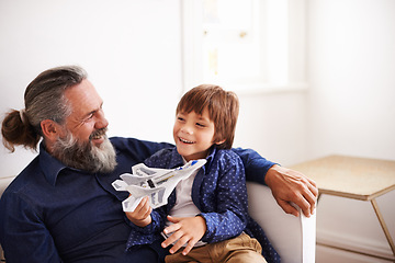 Image showing Dad, son and play with toy, airplane and fun in home or house with joy. Father, child and happiness with smile, youth and childhood development for future growth and bonding or single parent care