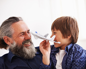 Image showing Grandfather, kid and play with toy, plane and fun in home or house with joy. Mature man, child and happiness with smile, youth and childhood development for future growth and bonding or care together