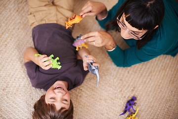 Image showing Woman, kid and toy with dinosaur, carpet and play for joy or fun at family home or house. Mother, child and bedroom with bonding, childhood and future development or growth for high angle happy care