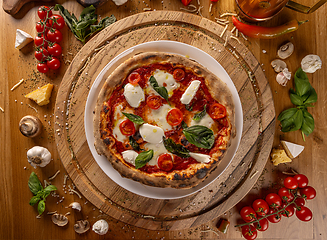 Image showing Delicious Italian pizza on rustic wooden table