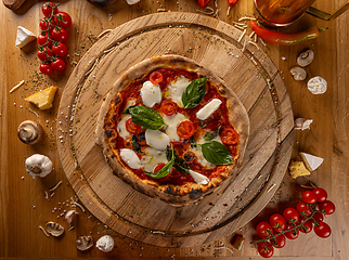 Image showing Delicious pizza surrounded by fresh ingredients