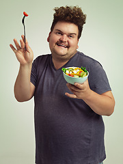 Image showing Smile, plus size and man with salad in studio for detox, healthy diet and nutrition for weight loss. Happy, male person and excited with organic food for wellness, vitamin c and lifestyle change