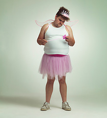 Image showing Fairy, man and studio portrait for magic and isolated, sad male person with wings and pretend costume. Pink Cosplay, depressed and mature plus size model, dress up or role play on white background