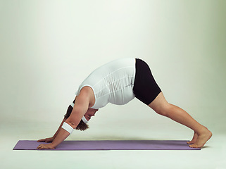 Image showing Man, plus size and exercise with mat in studio on white background with stretching or workout and fitness. Healthy, confident and progress with body positivity for self care, wellness and wellbeing