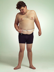 Image showing Man, plus size and stomach with measurement in studio on white background with tape for progress, weight loss and exercise. Positivity, fitness and body with self care to monitor health and shape