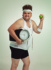 Image showing Scale, man and portrait with apple for health, fitness or nutrition isolated on gray studio background mockup. Plus size, body and eating fruit for weight loss diet of male person with tape measure