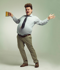 Image showing Man, beer and proud with belly for celebration, drink or party on a studio background. Male person or plus size model with glass or mug in satisfaction for beverage, wine or drinking on mockup space