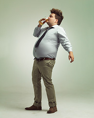 Image showing Studio, drunk and man with beer or alcohol with pint glass to drink, professional and profile. Adult, male person and guy with beverage for break, fun and crazy in party with liquid from mug