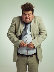 Image showing Plus size, man and fitting in shirt for abdomen, professional and annoyed with clothes for work. Adult, male person and guy with stomach, unhappy and upset with of belly in suit for job in studio