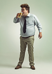 Image showing Man, face and drinking with beer for party or chug in obesity on a studio background. Young male person or plus size model with glass, mug or alcohol in satisfaction for brew or booze on mockup space