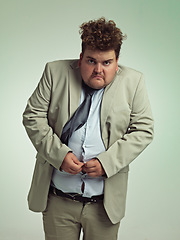 Image showing Portrait, plus size and man with stomach in shirt for suit, professional and annoyed with clothes for work. Employee, male person and guy with unhappy with fail of belly in attire for job in studio