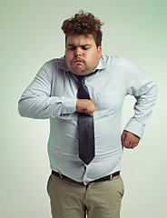 Image showing Sick, employee and man with vomit, unhealthy and professional in suit with fist on chest. Adult, male person and guy with risk of collapse, pain and cardiac arrest of entrepreneur in studio