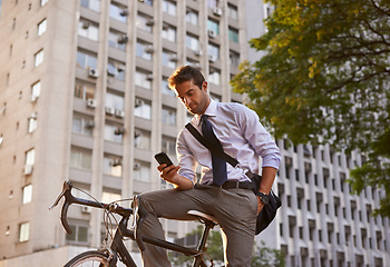 Image showing Bicycle, businessman and smartphone for sustainable travel, transportation and communication in city. Cellphone, commute and male employee on bike for cycling, carbon neutral or texting in urban town