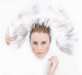 Image showing Hair, skincare and woman in milk bath for beauty, wellness and relaxing spa pamper treatment. Portrait, dermatology and face of female person with natural cosmetic routine in white dairy water.