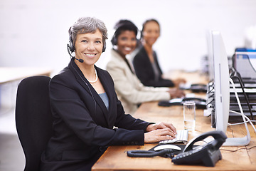 Image showing Call center, portrait and mature woman with team in office for crm training, learning or mentorship. Telemarketing, face or lady manager with group for customer support coaching, help or contact us