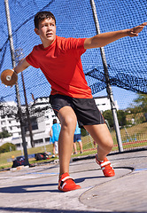 Image showing Discus, young man and sportsman throw in competition, championship or training for outdoor field event. Sports, metal disc and male person for fitness, athletics and tournament in strong contest