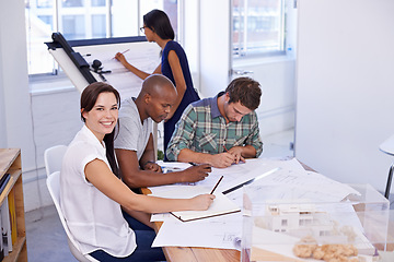Image showing Happy woman, creative and portrait with architect team for meeting, planning or architectural design at office. Designer with smile, documents or paperwork in group project or startup at workplace