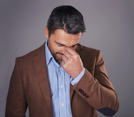 Image showing Business man, eye strain and stress in studio, burnout and suffering from headache or pain. Male person, migraine and gray background for mental health, frustration and overwhelmed by pressure of job