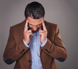 Image showing Business man, headache and stress in studio, burnout and fear or temple massage for pain. Male person, migraine and gray background for mental health, frustration and overwhelmed by pressure