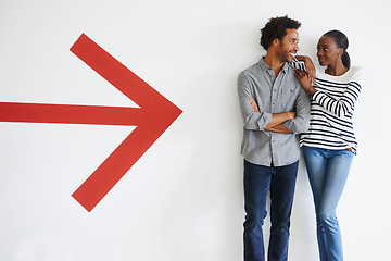 Image showing Couple, love and happiness with arrow by wall in car park with mockup space and romance with smile. African people, embrace and arms crossed in parking area with direction, sign and symbol of icon