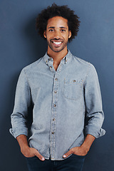 Image showing Happy man, portrait and confident in studio as creative professional and casual fashion by blue background. Young person, face or smile for ambition as designer in trendy clothes or pride in mock up