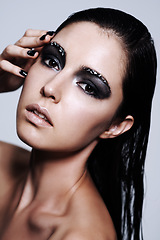 Image showing Woman, eyeshadow and portrait for skincare, makeup and manicure for cosmetic in studio. Model, beautiful and attractive with lipstick for shine and glow with shimmer, smokey and glitter for bold
