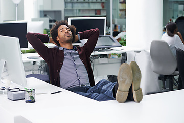 Image showing Break, relax or sleep with business man at desk in office, feet up for finished project and task. Computer, eyes closed and rest with confident young employee in workplace for complete or done work