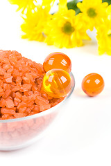 Image showing bath salt, oil balls in a bowl and yellow flowers