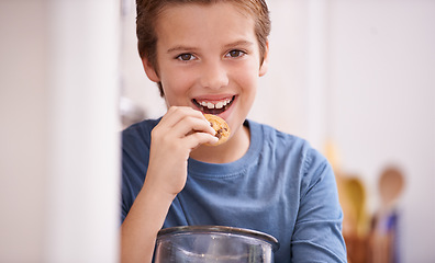 Image showing Eating, cookies and happy portrait of child in home with glass, container or jar of sweets in kitchen. House, snack and kid craving a taste of sugar from addiction to biscuit and unhealthy food