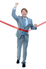 Image showing Happy, businessman and running with finish line for success, completion or victory on a white studio background. Excited man or employee with smile and fist pump in celebration for winning on mockup