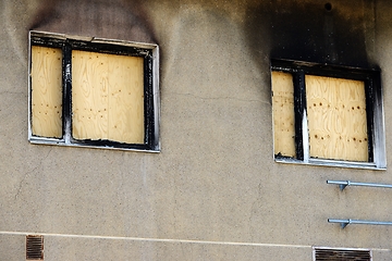 Image showing windows boarded up with plywood after a fire
