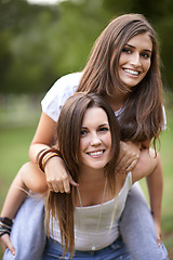 Image showing Portrait, smile and couple of friends with piggyback ride for bonding, adventure and summer vacation in outdoor. Happy, relax and woman carrying lady for fresh air, support and park together