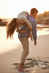 Image showing Beach, man and woman with playful love together for romantic date, travel or holiday on island. Ocean, vacation and couple smile in sand for tropical adventure for honeymoon, anniversary and sunset