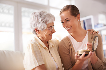 Image showing Gift box, necklace and senior mother with woman on sofa for present, giving and surprise in living room. Family, pearls and happy daughter with mom heirloom for celebration, birthday and bonding