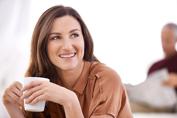 Image showing Woman, happy and coffee at home in the morning on a sofa with relax and calm thinking. Couple, couch and living room with a female person with smile and idea in a house lounge with hot drink