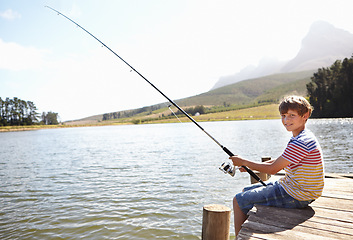Image showing Happy child, portrait and fishing by lake or nature for outdoor adventure, learning and sustainability. Excited kid or boy relax on dock with rod, line or pole for food, holiday or vacation in mockup