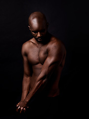 Image showing Black man, muscle and beauty on a dark background for dermatology and shadow or light with art deco or aesthetic. Bodybuilder, model or strong person in studio with arms, workout and fitness results