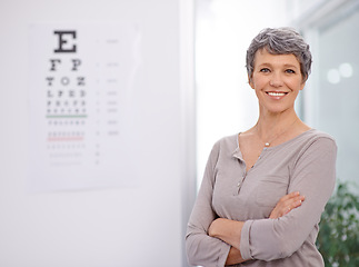 Image showing Woman, smile and portrait of optometrist in office with confidence, eye exam and medical test. Healthcare, mature employee and happy with sight support, wellness and chart for vision assessment