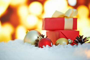 Image showing Gift box, lights and Christmas background with closeup for holiday, celebration and giveaway in winter at night. Empty, bokeh and home with present, package and thanksgiving in gratitude or tradition