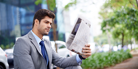 Image showing Professional, businessman and reading newspaper in city for information, daily news and updates on local events. Outdoors, male person and serious with article for stories, journalism and newsletter