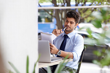 Image showing Laptop, pen and paper for thinking businessman, notepad and outside cafe for online work. Pensive, internet and technology for email for professional male person, notes and reports or paperwork