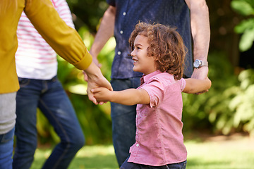 Image showing Happy family, holding hands and kid dance outdoor or play game in summer together in a circle at park. Ring a rosy, smile and child in garden on holiday, vacation and bonding with parents in nature