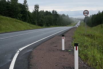 Image showing suburban road with one car and no overtaking sign