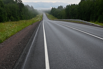 Image showing empty country road on a foggy evening