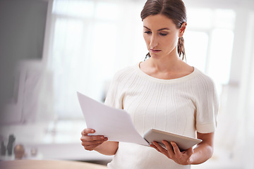 Image showing Businesswoman reading, paperwork and tablet in office or technology, online documents with serious person. Entrepreneur, creative business planning and internet, social media website and browsing