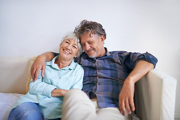 Image showing Old couple, hug and relax on sofa with happiness at home, love and security with comfort for bonding. Marriage, partner and retirement together with smile, trust and loyalty with people in lounge