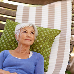 Image showing Senior woman, vision and outdoor with hammock to relax for retirement, break and enjoy. Thinking, female person and home with memories in summer or hot weather and satisfied with me time.