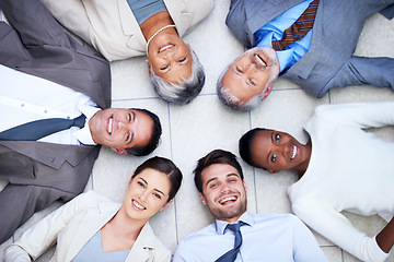 Image showing Floor, circle and portrait of team with smile for support, collaboration and solidarity. Professional employees, happy and diversity in office with trust, unity and partnership together from above