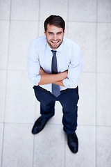 Image showing Business, portrait and high angle of man with arms crossed in office with confidence and pride. Above, entrepreneur and person in lobby to start morning in corporate London workplace with perspective