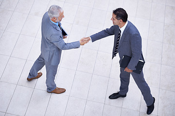 Image showing Top view of business people, CEO or shaking hands for hiring, collaboration or teamwork. Handshake, partnership or proud employee in corporate agreement with meeting success, welcome or thank you